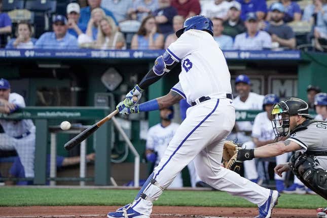 May 8, 2023; Kansas City, Missouri, USA; Kansas City Royals catcher Salvador Perez (13) hits a one run sacrifice fly against the Chicago White Sox in the first inning at Kauffman Stadium.
