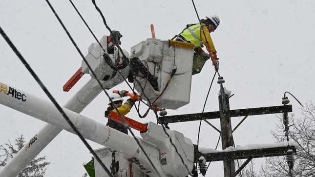 Workers fix a utility line Tuesday in Ballston Lake, New York.