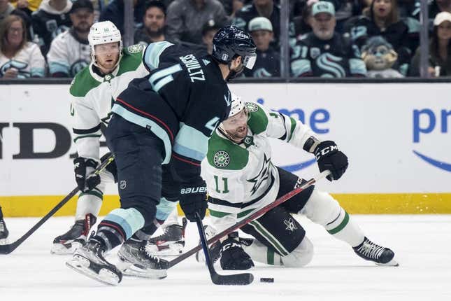 May 7, 2023; Seattle, Washington, USA; Dallas Stars forward Luke Glendening (11) battles Seattle Kraken defenseman Justin Schultz (4) for the puck during the third period in game three of the second round of the 2023 Stanley Cup Playoffs at Climate Pledge Arena.
