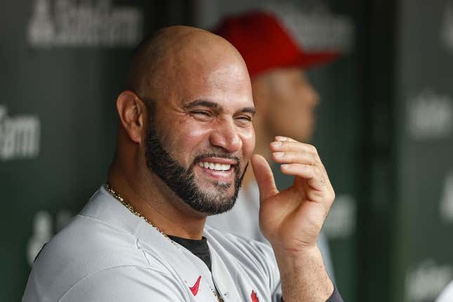 Aug 25, 2022; Chicago, Illinois, USA; St. Louis Cardinals designated hitter Albert Pujols (5) smiles in the dugout during the ninth inning against the Chicago Cubs at Wrigley Field.