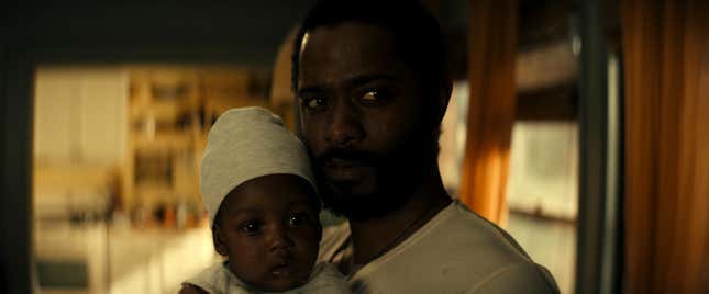 Apollo (LaKeith Stanfield) holds a baby in The Changeling