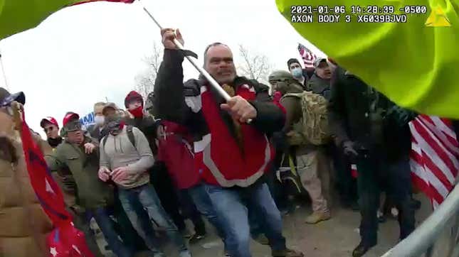 This still frame from Metropolitan Police Department body worn camera video shows Thomas Webster, in red jacket, at a barricade line at on the west front of the U.S. Capitol on Jan. 6, 2021, in Washington. Retired New York City police officer Webster is the next to go on trial, with jury selection scheduled to begin Monday, April 25, 2022. Webster has claimed he was acting in self-defense when he tackled a police officer who was trying to protect the Capitol from a mob on Jan. 6.