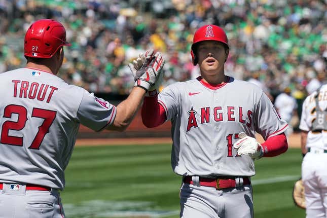 Apr 1, 2023; Oakland, California, USA; Los Angeles Angels designated hitter Shohei Ohtani (17) is congratulated by center fielder Mike Trout (27) after scoring a run against the Oakland Athletics during the third inning at RingCentral Coliseum.