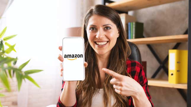 A woman with vacant eyes pointing to an Amazon logo on her smartphone's screen and smiling a hollow smile