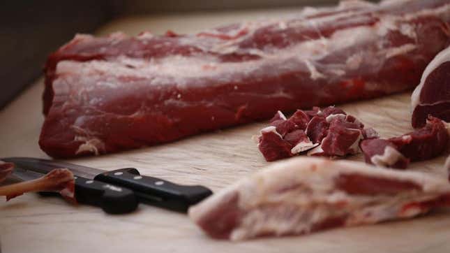 Raw meat on table with steak knives