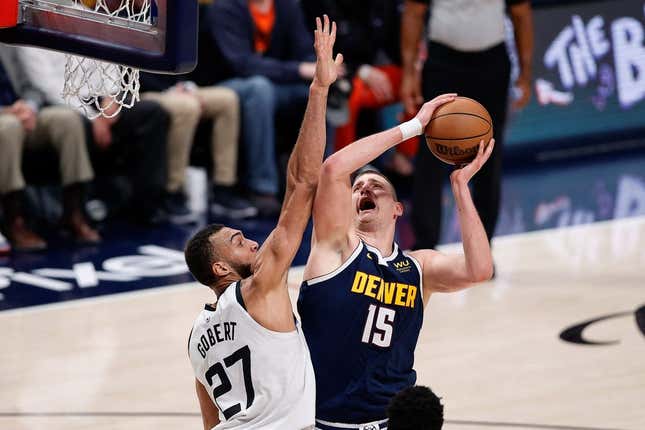Apr 19, 2023; Denver, Colorado, USA; Denver Nuggets center Nikola Jokic (15) drives to the net against Minnesota Timberwolves center Rudy Gobert (27) in the second quarter during game two of the 2023 NBA Playoffs at Ball Arena.