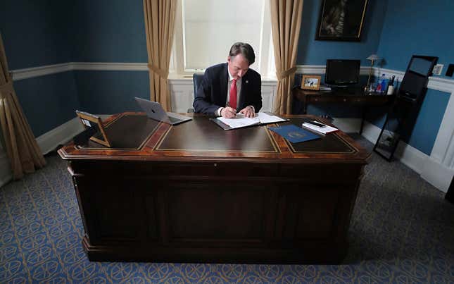 Virginia Gov. Glenn Youngkin works at his desk inside his private office at the State Capitol in Richmond, Va., Jan. 18, 2022.