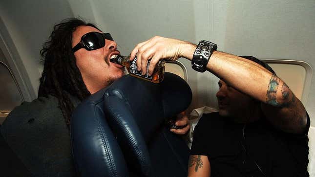 Korn drinking Jack Daniels on a private flight