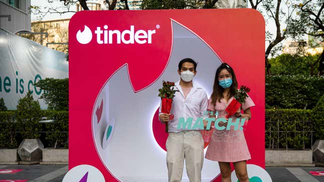 A Thai couple poses at a Tinder booth on Valentines Day on February 14, 2022 in Bangkok, Thailand. Thai people take part in a prayer ceremony sponsored by Tinder at the Trimurti Shrine, nicknamed the "shrine of love", on Valentines Day. 
