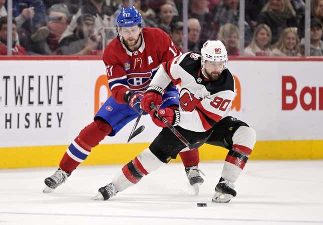 Mar 11, 2023; Montreal, Quebec, CAN; New Jersey Devils forward Tomas Tatar (90) plays the puck and Montreal Canadiens forward Josh Anderson (17) defends during the second period at the Bell Centre.