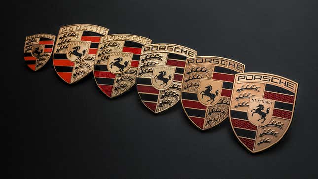 A photo of six different Porsche badges. 