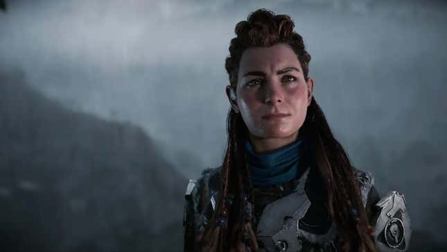 Series protagonist Aloy stands with raindrops on her face against a fuzzy mountainous background.