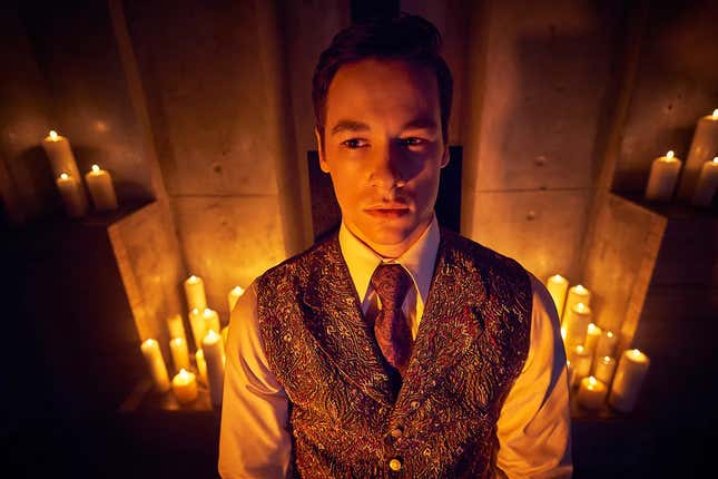 Kyle Allen wearing a vest and tie, surrounded by a bunch of candles.
