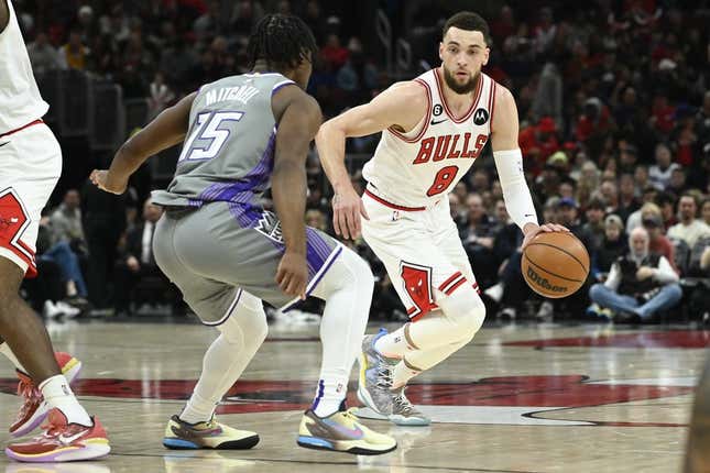 Mar 15, 2023; Chicago, Illinois, USA; Chicago Bulls guard Zach LaVine (8) moves the ball past Sacramento Kings guard Davion Mitchell (15) during the first half at the United Center.
