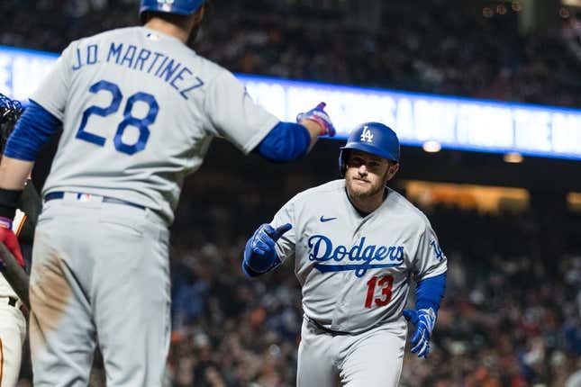 Apr 12, 2023; San Francisco, California, USA;  Los Angeles Dodgers third baseman Max Muncy (13) is congratulated by designated hitter J.D. Martinez (28) after he hit a solo home run against the San Francisco Giants during the fifth inning at Oracle Park.