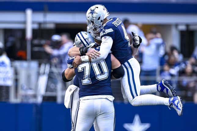 Oct 30, 2022; Arlington, Texas, USA; Dallas Cowboys quarterback Dak Prescott (4) and guard Zack Martin (70) celebrates a touchdown  scored by running back Tony Pollard (not pictured) during the second half against the Chicago Bears at AT&amp;amp;T Stadium.