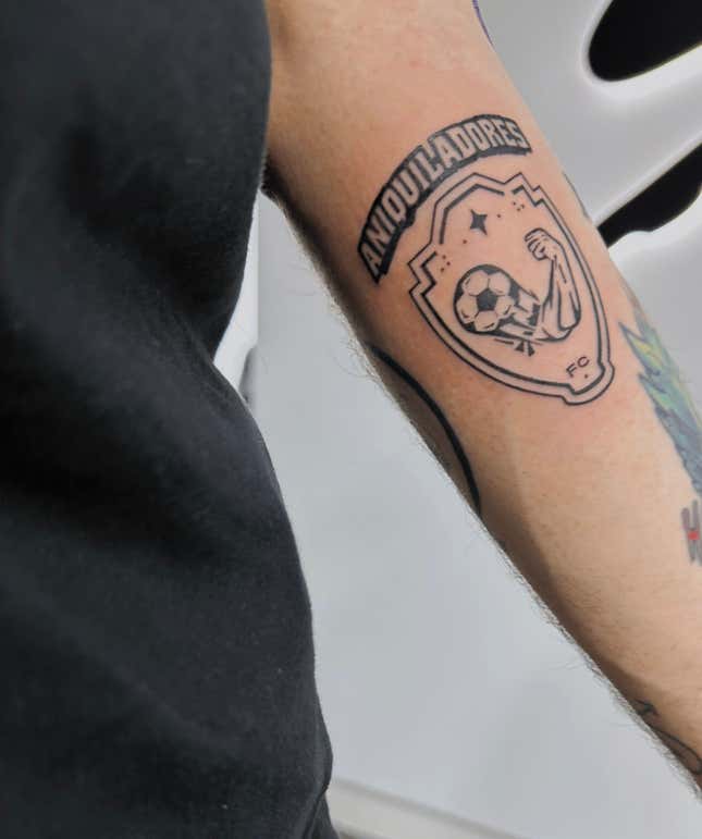A photo of Juan Guarnizo's Aniquiladores' tattoo, a muscled arm with a soccer ball at the base.