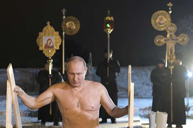 Russian President Vladimir Putin walks out of a hole in the ice after taking a dip in the freezing waters of Lake Seliger.