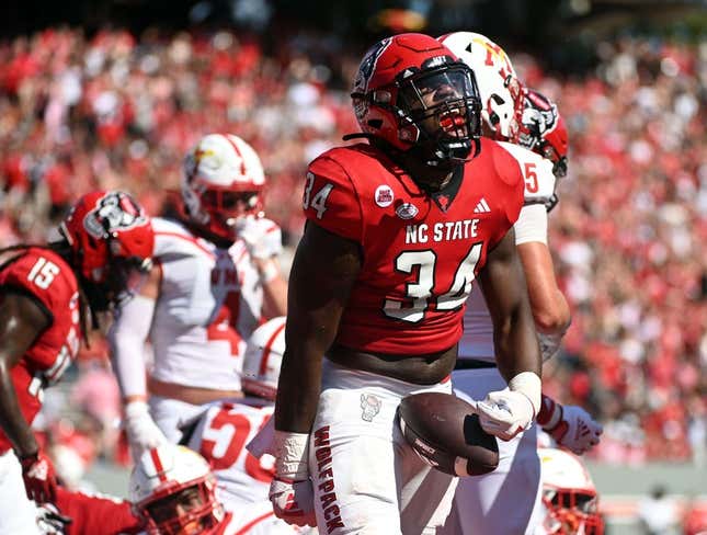 Sep 16, 2023; Raleigh, North Carolina, USA; North Carolina State Wolfpack running back Delbert Mimms III (34) celebrates a touchdown during the first half against the Virginia Military Institute Keydets at Carter-Finley Stadium.