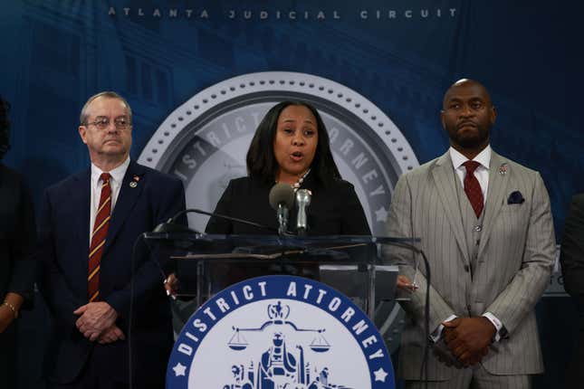 Fulton County DA Fani Willis stands at a podium and speaks during a news conference.