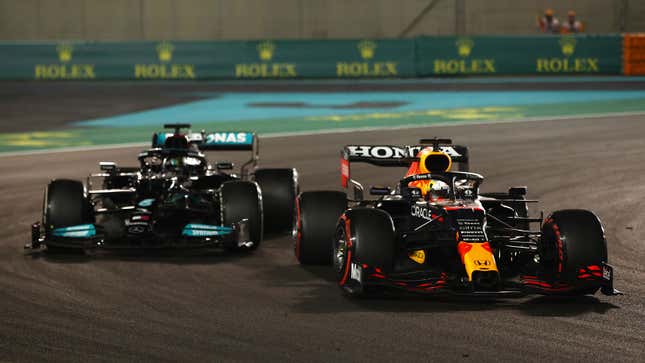 A photo of Max Verstappen passing Lewis Hamilton. 