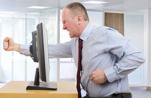 A man punching a computer