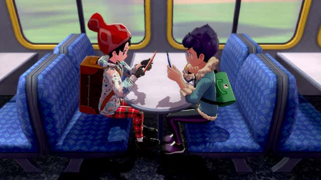 A Pokémon trainer and Hop are seen riding on a train and looking at their phones.