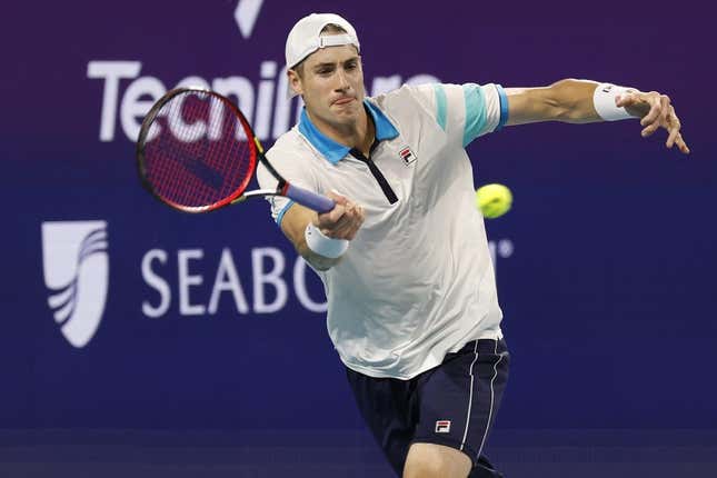 Mar 22, 2023; Miami, Florida, US; John Isner (USA) hits a forehand against Emilio Nara (USA) (not pictured) on day three of the Miami Open at Hard Rock Stadium.