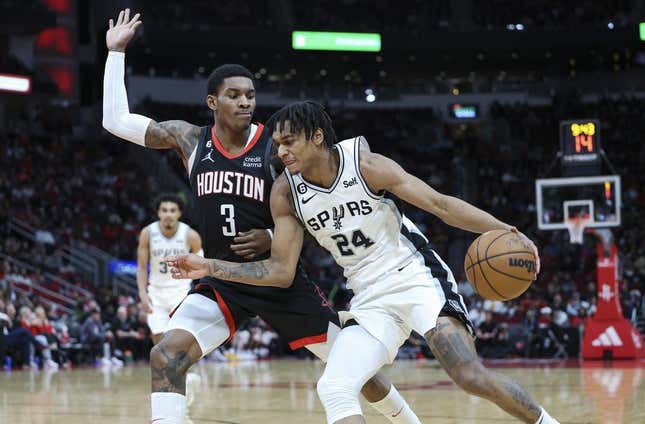 Dec 19, 2022; Houston, Texas, USA; San Antonio Spurs guard Devin Vassell (24) attempts to dribble the ball around Houston Rockets guard Kevin Porter Jr. (3) during the third quarter at Toyota Center.