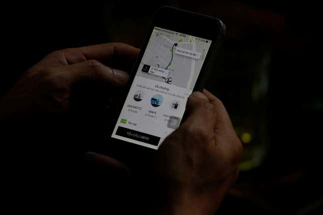 A client uses a smartphone to book Uber service in Hanoi, Vietnam 