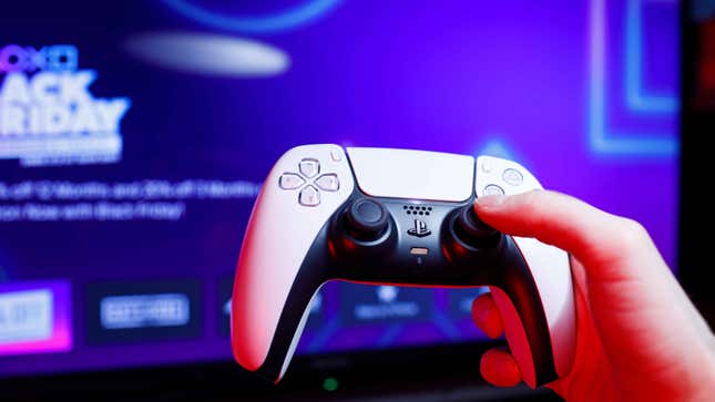 A player holds a PS5 controller in front of a TV.
