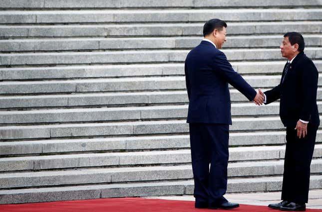 Philippines President Rodrigo Duterte and Chinese President Xi Jinping shake hands in Beijing.