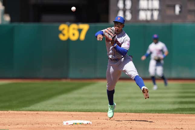 Apr 16, 2023; Oakland, California, USA; New York Mets shortstop Francisco Lindor (12) throws the ball to first base to record an out against the Oakland Athletics during the third inning at RingCentral Coliseum.