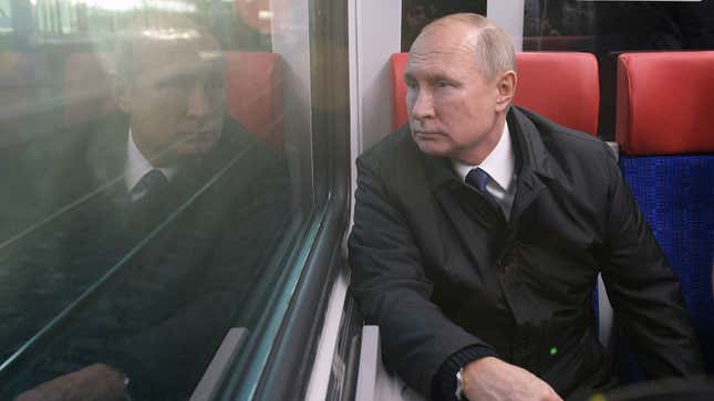 A photo of Vladimir Putin sat on a train. 
