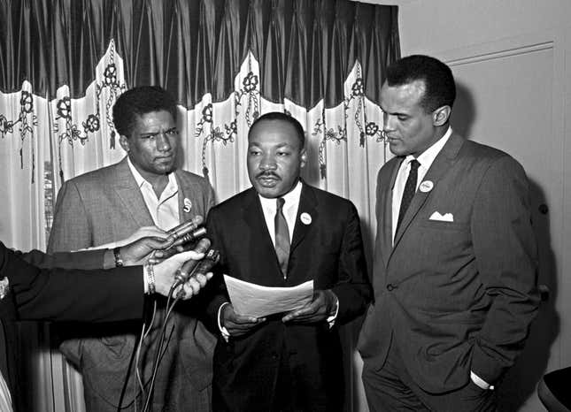 James Foreman, executive secretary of the Student Non-violent Coordinating Committee, left, Civil Rights leader Dr. Martin Luther King Jr., center, head of the Southern Christian Leadership Conference and activist-singer Harry Belafonte appear during a press conference in Atlanta on April 30, 1965.