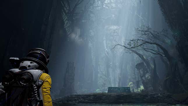 An image from Returnal of protagonist Selene Vassos walking toward decrepit trees illuminated by a skylight.