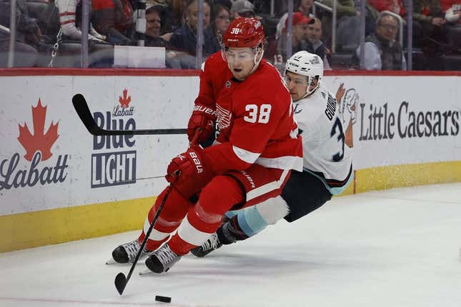 Mar 2, 2023; Detroit, Michigan, USA;  Detroit Red Wings goaltender Ville Husso (35) skates with the puck chased by Seattle Kraken center Yanni Gourde (37) in the first period at Little Caesars Arena.