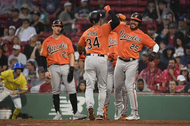 Sep 9, 2023; Boston, Massachusetts, USA;  Baltimore Orioles center fielder Aaron Hicks (34) is greeted at home plate by right fielder Anthony Santander (25) after hitting a three run home run during the third inning against the Boston Red Sox at Fenway Park.