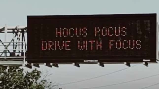Funny digital traffic sign which reads "Hocus Pocus, Drive With Focus" 