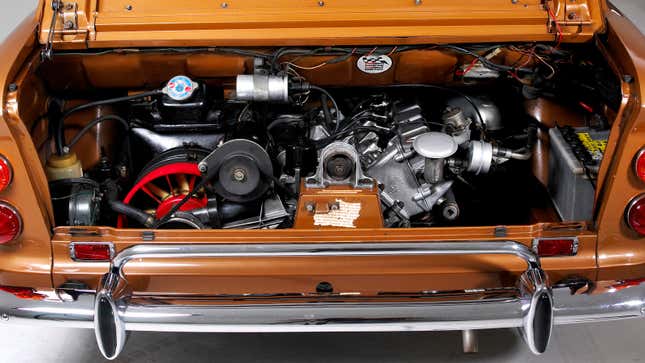 A photo of the engine bay in a vintage car. 