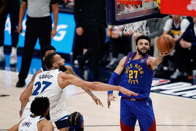 Apr 16, 2023; Denver, Colorado, USA; Denver Nuggets guard Jamal Murray (27)d rives to the net against Minnesota Timberwolves center Rudy Gobert (27) in the third quarter during game one of the 2023 NBA Playoffs at Ball Arena.