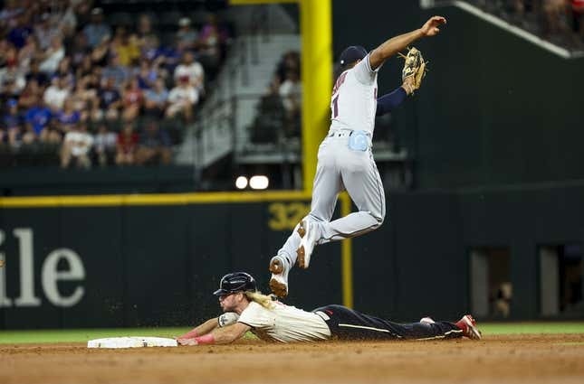 Jul 15, 2023; Arlington, Texas, USA;  Texas Rangers left fielder Travis Jankowski (16) slides safely into second base ahead of the tag by Cleveland Guardians shortstop Amed Rosario (1) during the second inning at Globe Life Field.