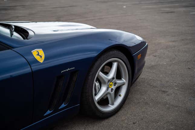 View of the front fender of a blue 1999 Ferrari 550 Maranello