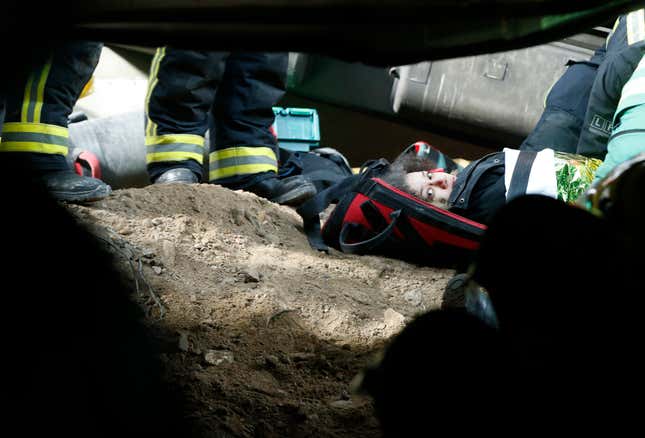 A simulated casualty waits on a stretcher.