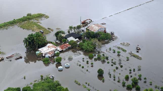 A farm house is surrounded by floodwaters in the town of Bli Bli on February 27, 2022. 