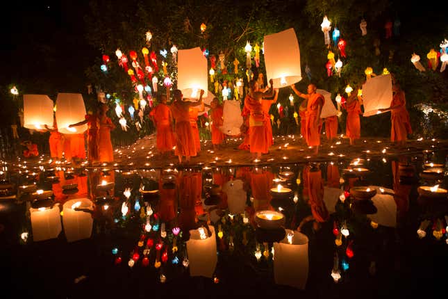 Buddhist monks prepare to release sky lanterns in Chiang Mai.