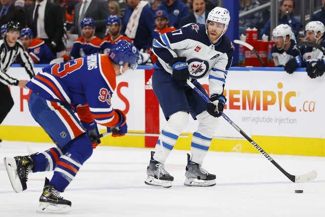 Mar 3, 2023; Edmonton, Alberta, CAN; Winnipeg Jets forward Adam Lowry (17) looks to make a pass against Edmonton Oilers forward Ryan Nugent-Hopkins (93) during the second period at Rogers Place.