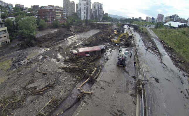 Rescuers work on a flooded Tbilisi street.