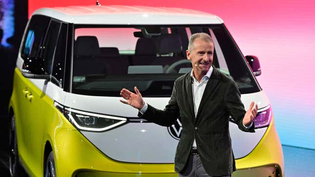 A photo of VW CEO Herbert Diess stood in front of an ID Buzz electric van. 