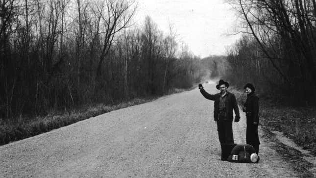 A black and white photograph of two hitchhikers 
